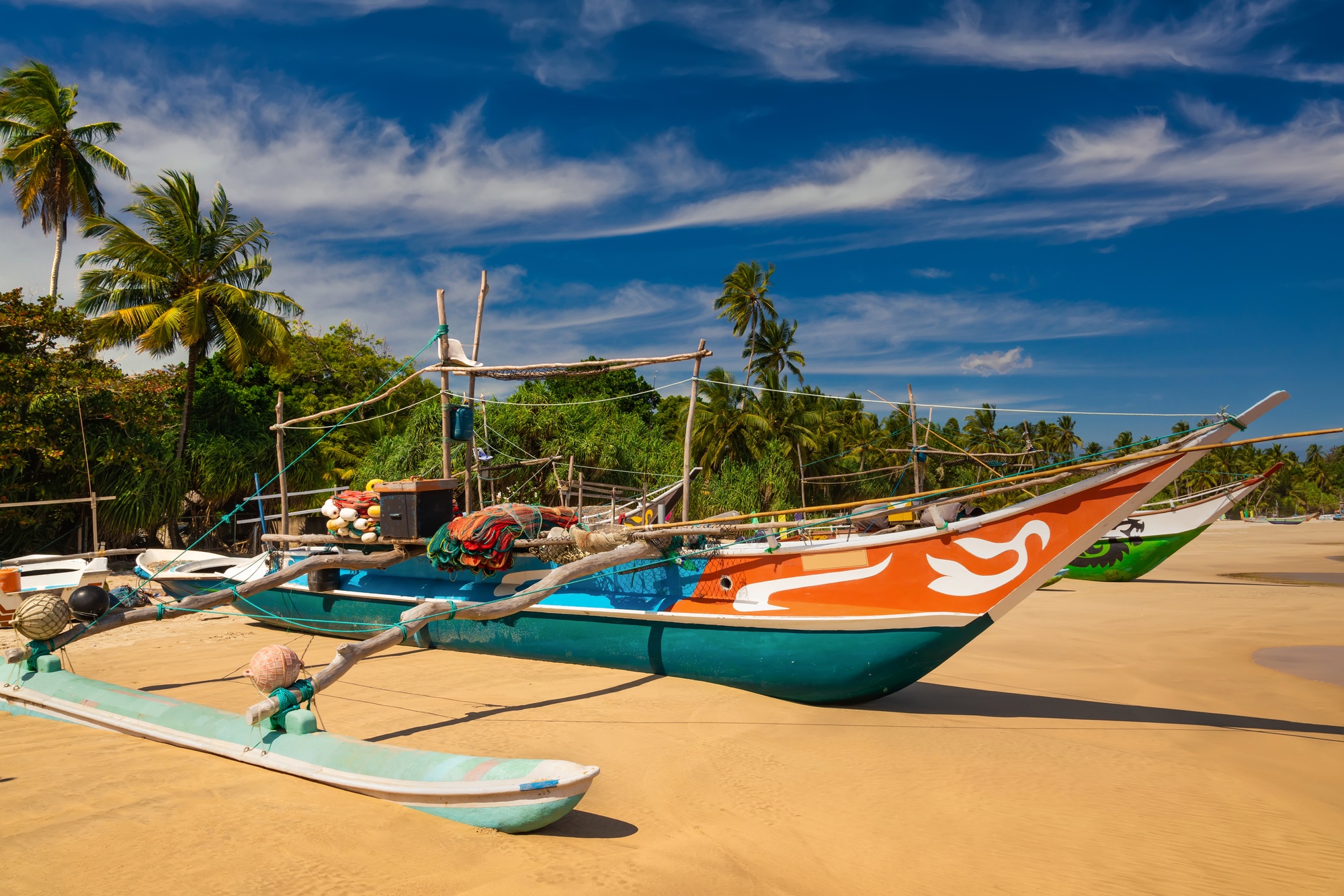 Traditional fishing boats on a sandy beach. Sri Lanka